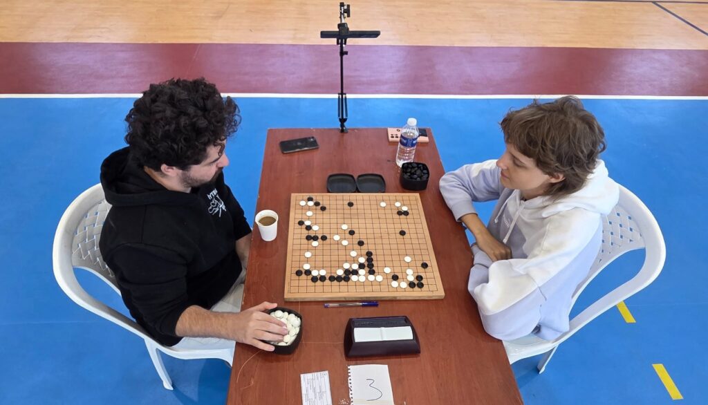 Two players at a go board during the championship