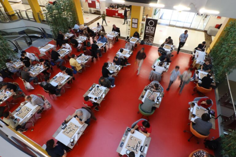 View from above of the playing hall with players at their boards