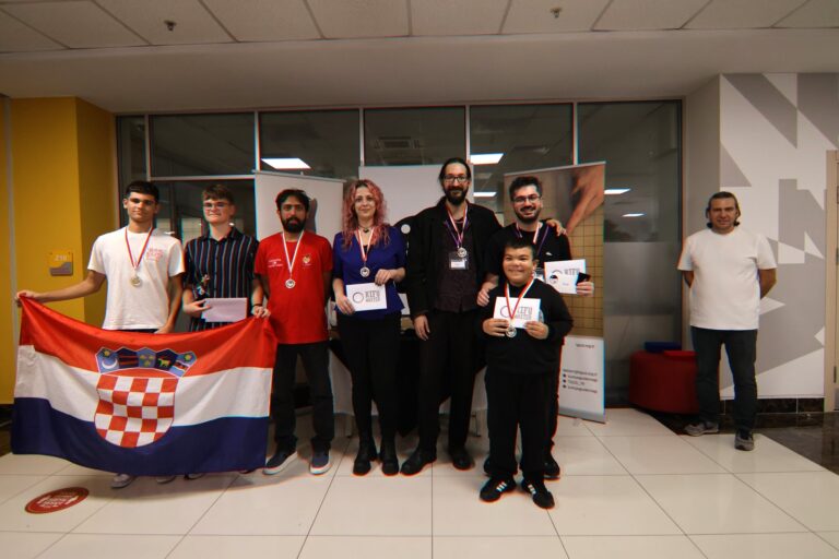 Prize winners with medals standing behind a Croatian flag