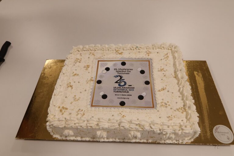 A white cake decorated with the 25th tournament logo